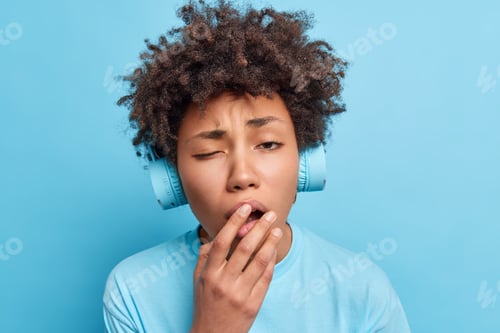 Preview: Sleepy Afro American Girl Feels Bored Learns Foreign Words While Listening Audio Tracks Via