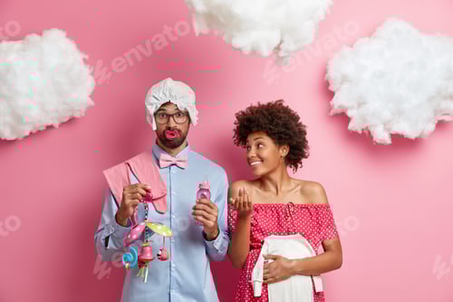 Preview: Responsible Childbirth Planning. Happy Mother, Father Prepare For Parenthood, Buys Clothes For