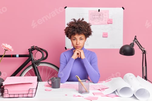Young Woman Architect Working at Desk in Pink Office