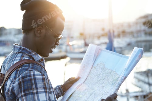 Preview: Youth And Travel Concept. Half-Profile Portrait Of Dark-Skinned Hipster-Looking Tourist Just