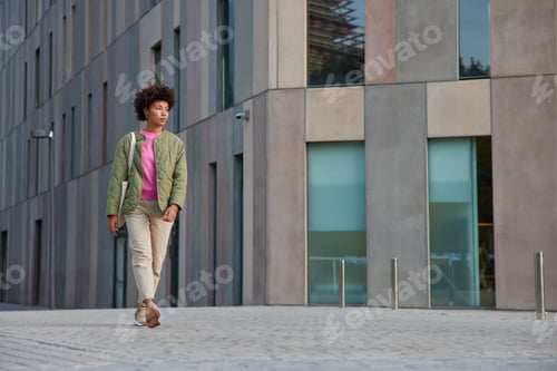 Preview: Outdoor Shot Of Stylish Afro American Woman Stolls In City Discovers New Places Of Interest Has