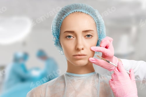 Preview: Portrait Of Attractive Young Woman Getting Cosmetic Injection In Face With Medical Workers In The
