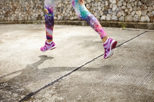 Preview: Freeze Action Shot Of Female Runner In Purple Sneakers Training Outdoors, Jogging Along Concrete