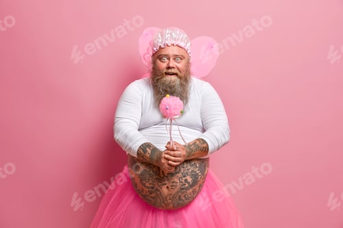 Preview: Horizontal Shot Of Bearded Fatso Man Foolishes Around On Childrens Birthday Party, Holds Magic Wand