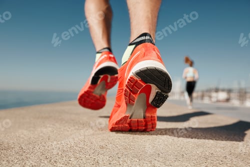 Preview: Close Up Runner Feet. Man Runner Legs And Shoes In Action On Road Outdoors At Road Near Sea. Male