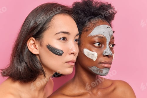 Preview: Sideways Shot Of Serious Multiethnic Women Concentrated Into Distance Apply Clay Mask On Faces