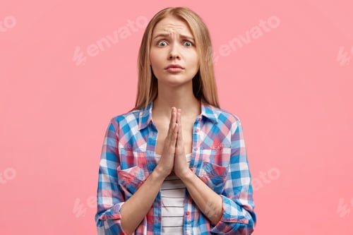 Preview: Attractive Young Blonde Woman Begs For Mercy With Praying Gesture And Sorrowful Expression, Hopes