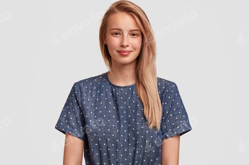 Preview: Waist Up Portrait Of Blonde Optimistic Young Female Model Has Pleased Expression, Stands Alone