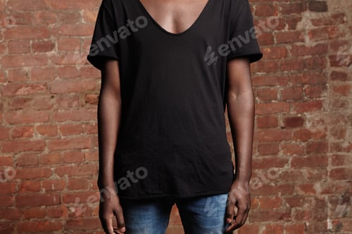 Preview: Cropped View Of Young African Man With Athletic Body Dressed In Blue Jeans And Black T-Shirt With