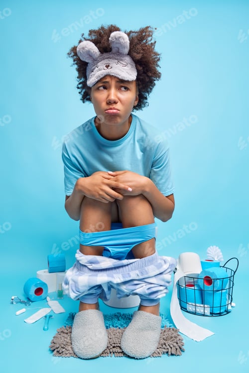 Preview: Displeased Afro American Woman Has Dissatisfied Expression Suffers From Constipation Poses On