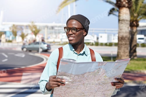 Preview: Outdoor Shot Of Carefree And Relaxed Young Dark-Skinned Student Dressed In Trendy Clothing Holding