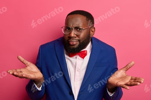 Preview: Uncertain Dark Skinned Man Spreads Palms With Hesitation, Has Doubtful Look, Wears Formal Clothing