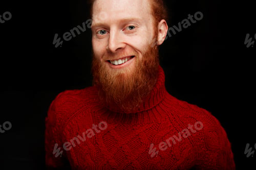 Preview: Happy Bearded Man. Handsome Young Bearded Man In A Red Knitted Sweater Smiling While Standing