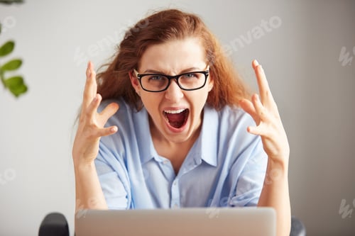 Preview: Portrait Of A Young Attractive Businesswoman With Frustrated Look Working On Laptop At Office