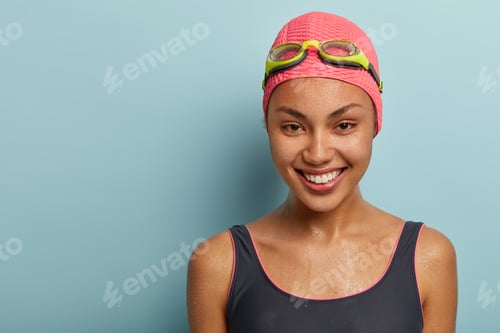 Preview: Headshot Of Pretty Positive Female Recreats On Sea, Has Wet Skin After Swimming, Dressed In