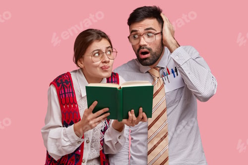 Preview: Horizontal Shot Of Surprised Female Wonk And Her Classmate Look Confusingly And With Astonishment