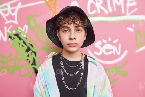 Preview: Serious Handsome Hipster Guy Looks Directly At Camera Has Curly Hair Wears Black Stylish Hat