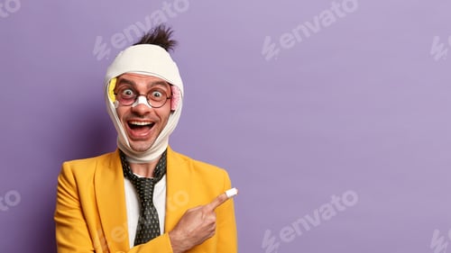 Preview: Happy Adult Man Has Broken Nose And Bruized Skin, Points Away On Copy Space Against Purple