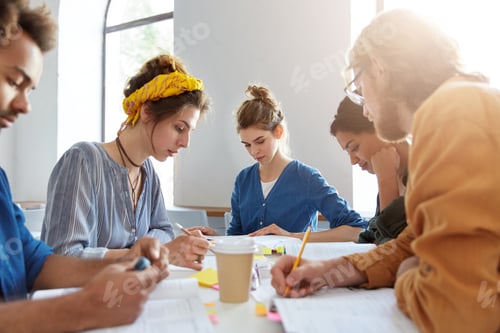 Preview: Candid Shot Of College Students Studying Together At Coffee Shop, Preparing For Lessons, Sitting At