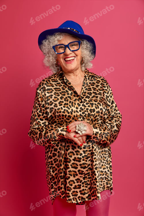 Preview: Vertical Studio Shot Of Attractive Happy Ederly Woman Wears Hat, Shirt With Leopard Print And