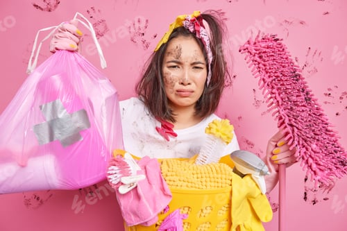 Preview: Unhappy Asian Woman With Dirty Face Has Tired Displeased Expression Collects Garbage At Home Holds