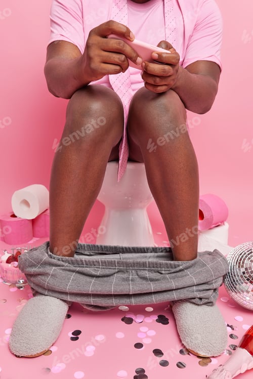 Preview: Cropped Shot Of Dark Skinned Man Addicted To Video Games Plays On Modern Smartphone While Sitting N