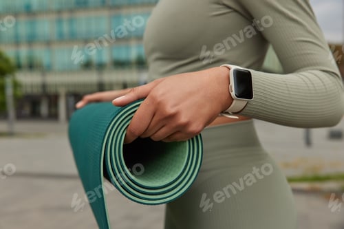 Preview: Cropped Shot Of Unrecognizable Woman In Sportswear Carries Rubber Rolled Karemat Prepares For