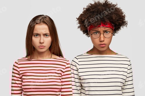 Preview: Horizontal Shot Of Displeased Female With Negative Expressions, Dressed In Striped Clothes, Have
