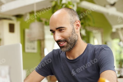 Preview: Adult Man With Beard Dressed Casually Using Modern Laptop Computer, Checking Email Or Messaging