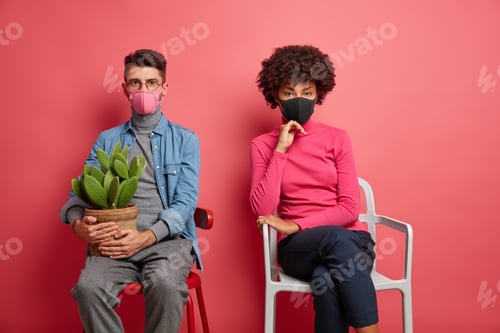 Preview: Photo Of Serious Woman And Man Wear Protective Face Masks Keep Social Distancing Look Directly At