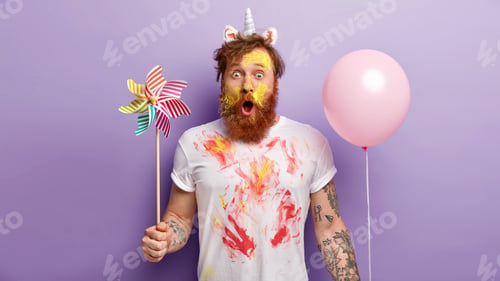 Preview: Bearded Adult with Unicorn Horn Holds Colorful Balloon