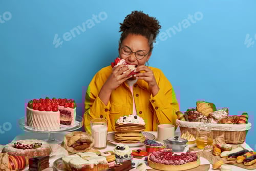 Preview: Hungry Curly African American Woman Bites Big Piece Of Cake, Feels Temptation After Diet, Sits At