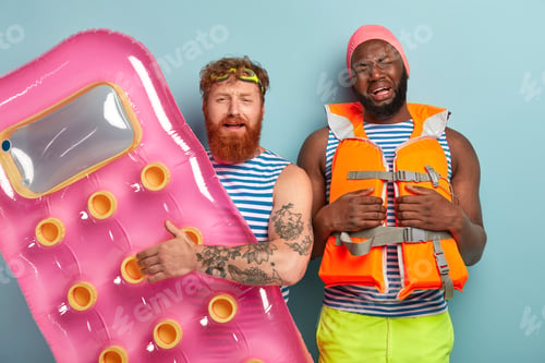 Preview: Discontent Dejected Multiethnic Friends Dissatisfied With Something, Pose With Swimming Equipment