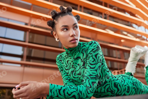 Preview: Horizontal Shot Of Dreamy Thoughtful Woman With Makeup Concentrated Aside Wears Green Costume Has