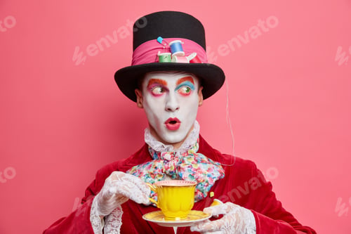 Preview: Stunned Man In Mad Hatter Costume Drinks Coffee And Looks Away Surprisingly Spends Free Time On
