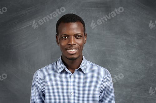 Preview: Portrait Of Attractive Dark-Skinned Student Wearing Checkered Shirt Looking At Camera With