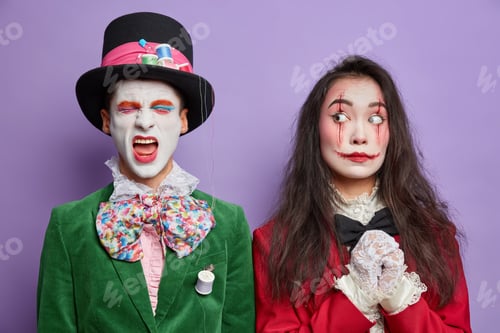 Preview: Creepy Halloween Couple With Professional Makeup Dressed In Costumes For Carnival Party Isolated