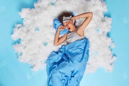 Preview: Sleepy Afro American Woman Awakes Early Stretches Arms Doesnt Want To Get Up Yawns Lies Under