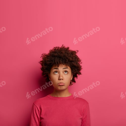 Preview: Pessimistic Dark Skinned Woman Has Regretful Mournful Look Above, Purses Lips, Looks Sadly At