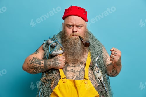 Preview: Strict Bearded Annoyed Fisherman Clenches Fist Angrily, Looks With Frowned Face, Uses Fishing Nets