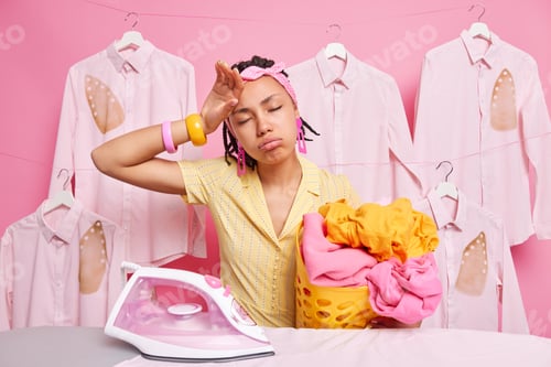 Preview: Fatigue Overworked Housewife Rubs Forehead Being Busy Doing Housework Holds Basket With Laundry