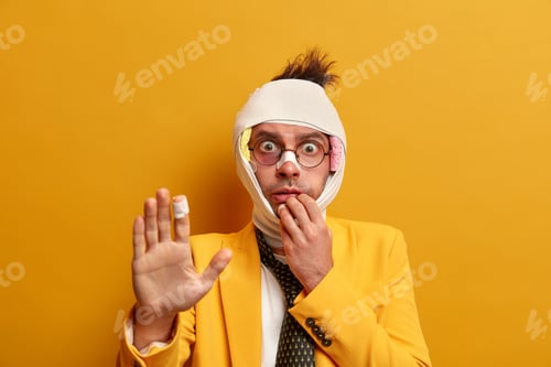Injured Man Bandaged Up Making Stop Gesture