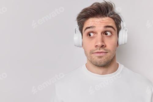 Preview: Photo Of Surprised Unshaven Guy Concentrated Away With Shocked Expression Has Widely Opened Eyes