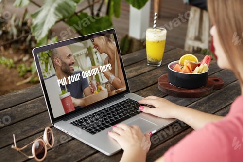 Visualização: Foto traseira de uma estudante em frente a um laptop aberto com as mãos no teclado, aprendendo on-line