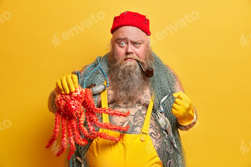 Preview: Adventure, Hobby, Fishing Concept. Angry Fisherman With Serious Strict Expression Clenches Fist