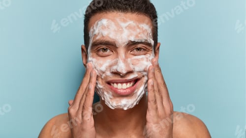 Preview: Photo Of Handsome Satisfied European Man Cleans And Washes Face With Soap, Enjoys Purity Of Skin