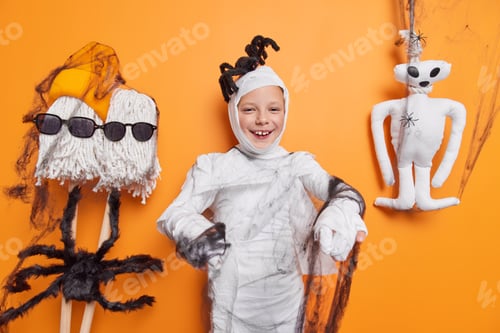 Preview: Little Children And Halloween Concept. Little Child Wrapped With White Fabric Black Spider Web