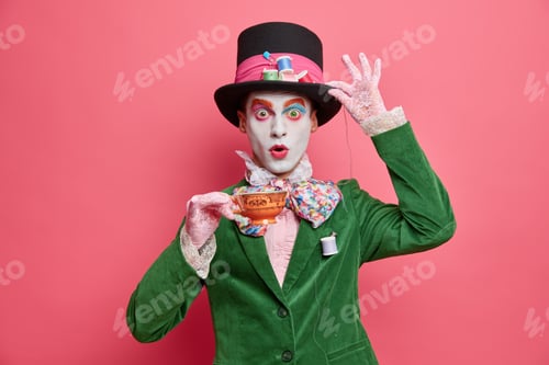 Preview: Photo Of Shocked Male Has Image Of Mysterious Hatter From Wonderland Wears Bright Makeup Poses With