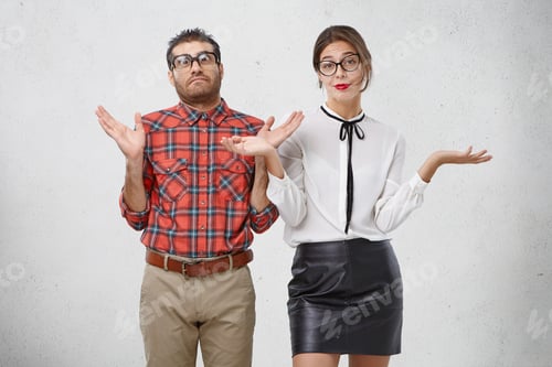 Preview: Two Clever People Shrug Shoulders And Gesture With Hands, Say Who Cares, Have Indignant Look