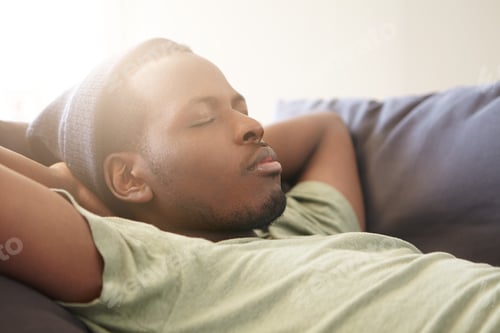 Preview: Sleeping Handsome Black Man With Full Lips Wearing Black Hat And Green T-Shirt Having Good Dreames